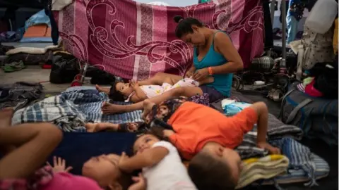 Reuters Frances, a migrant woman from Honduras taking refuge in a shelter with a caravan from Central America trying to reach the United States, dresses her one year old daughter Sujey in Tijuana, Mexico November 20, 2018.