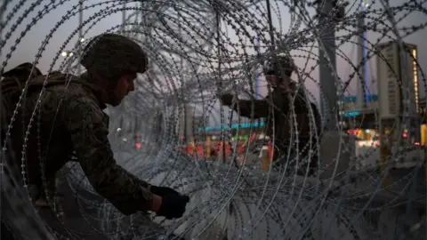 Reuters United States Marines fortify concertina wire along the San Ysidro Port of Entry border crossing as seen from Tijuana, Mexico November 20, 2018