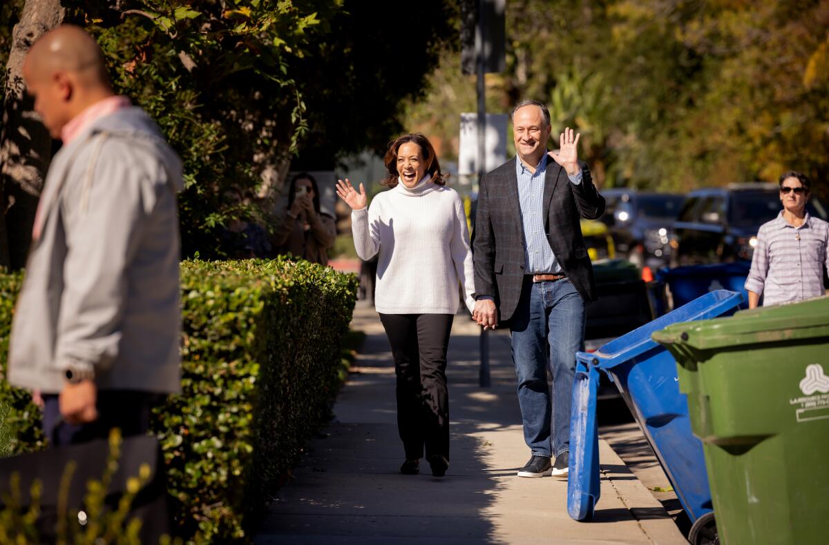 A photo of  Vice President Kamala Harris and Second Gentleman Douglas Emhoff walking through their neighborhood in L.A.