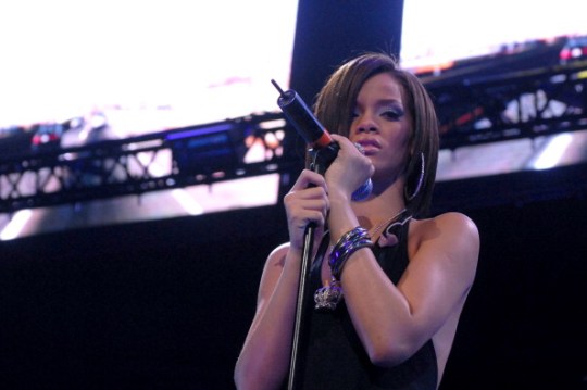 Rihanna sings into a microphone