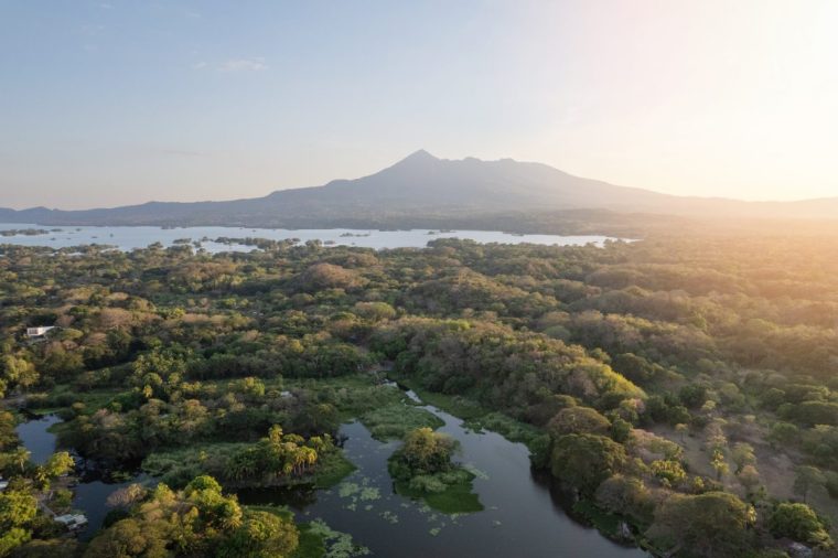 Mombacho volcano on sunset light aerial drone view