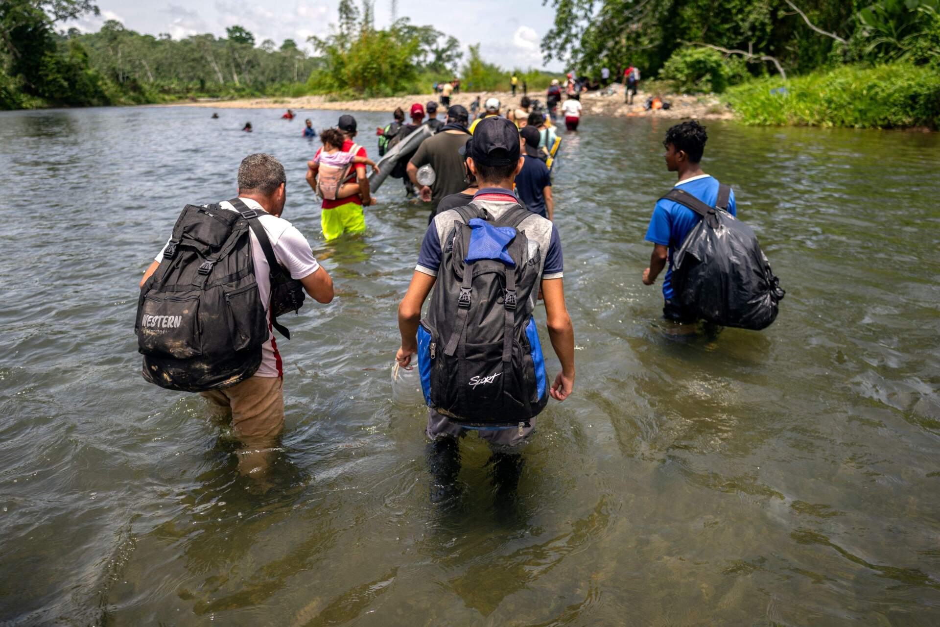 Migrants cross the Tuquesa River in 2023 through a portion of the Darién Gap in Panama. (Luis Acosta/AFP via Getty Images)