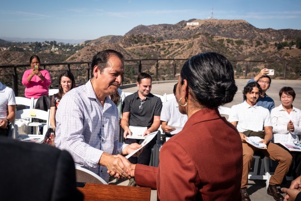 New U.S. Citizen Victor Martinez receives his citizenship papers from...