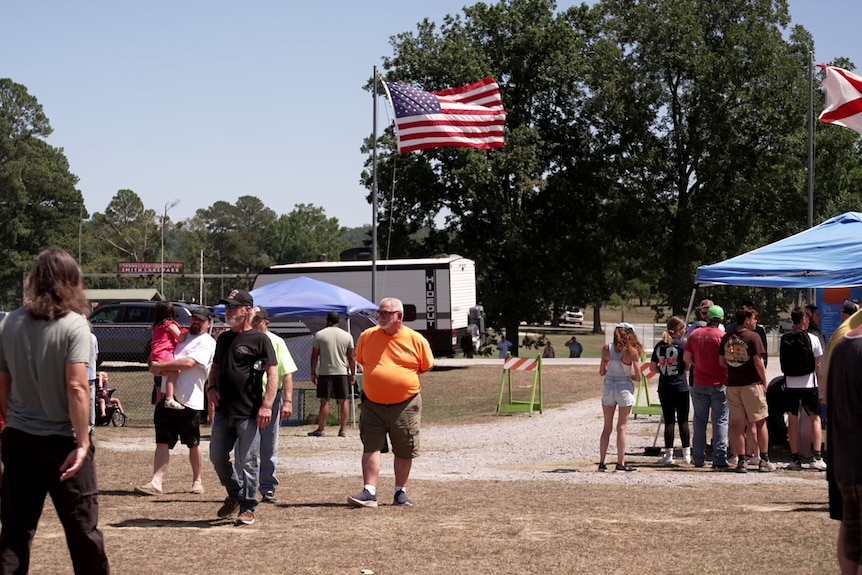 American flags fly over a dusty festival space