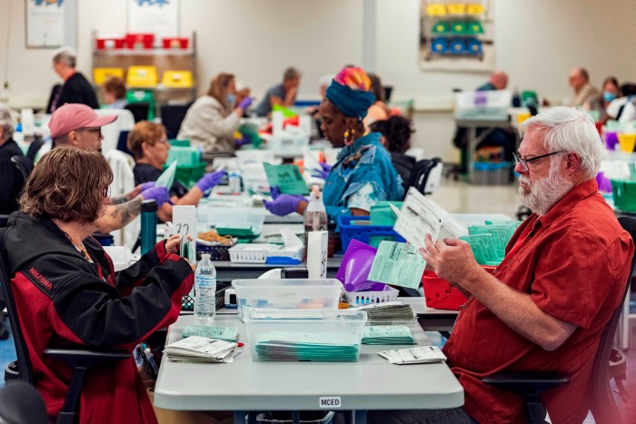 Election workers open envelopes and sort 2024 General Election ballots at the Maricopa County Tabulation and Election Center (MCTEC) in Phoenix, Arizona