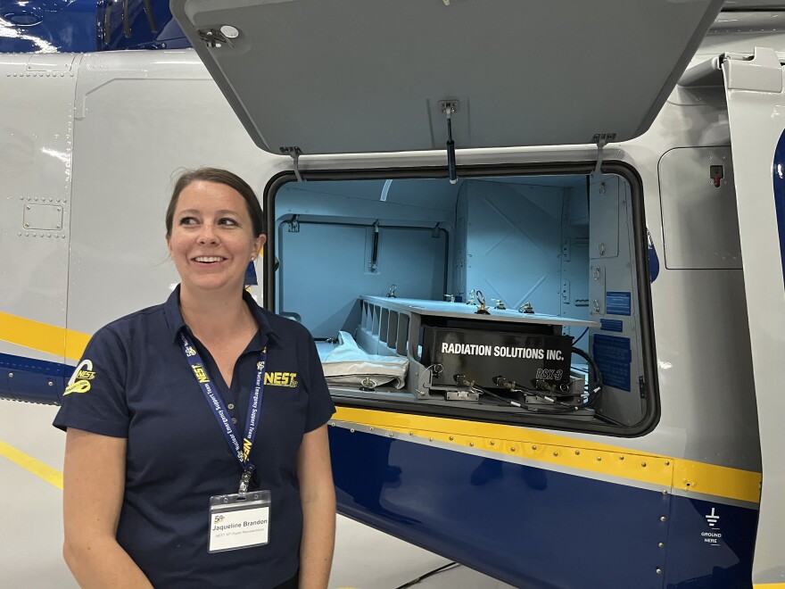 NEST scientist Jacqueline Brandon displays radiation detection equipment inside one of NEST's helicopters. 