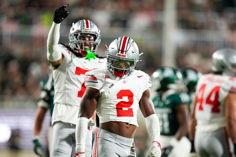 Sep 28, 2024; East Lansing, Michigan, USA; Ohio State Buckeyes safety Caleb Downs (2) celebrates after tackling Michigan State Spartans running back Nate Carter (5) in the first half at Spartan Stadium on Saturday.