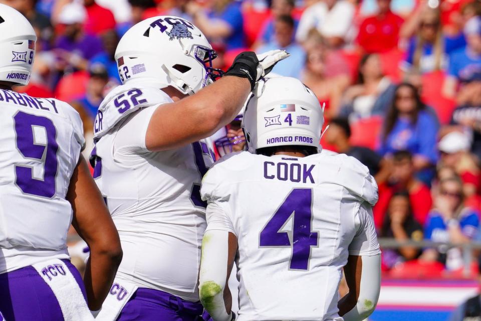 Sep 28, 2024; Kansas City, Missouri, USA; TCU Horned Frogs running back Cam Cook (4) celebrates with offensive lineman James Brockermeyer (52) after scoring against the Kansas Jayhawks during the first half at GEHA Field at Arrowhead Stadium. Mandatory Credit: Denny Medley-Imagn Images