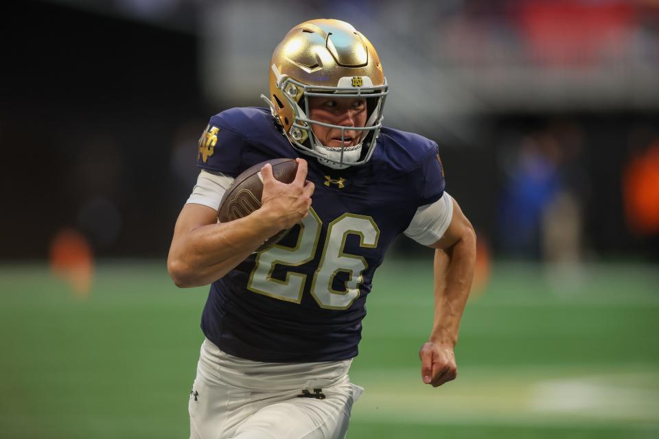 Oct 19, 2024; Atlanta, Georgia, USA; Notre Dame Fighting Irish holder Tyler Buchner (26) runs the ball on a fake field goal against the Georgia Tech Yellow Jackets in the fourth quarter at Mercedes-Benz Stadium. Mandatory Credit: Brett Davis-Imagn Images