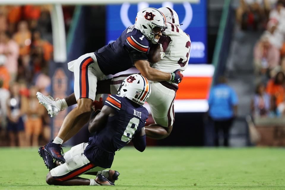 Aug 31, 2024; Auburn, Alabama, USA; Auburn Tigers safety Jerrin Thompson (1) and cornerback Antonio Kite (8) stop Alabama A&M Bulldogs wide receiver Jacolby Hewitt (3) during the second quarter against the Alabama A&M Bulldogs at Jordan-Hare Stadium. Mandatory Credit: John Reed-USA TODAY Sports