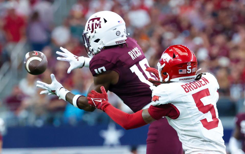 Sep 28, 2024; Arlington, Texas, USA; Texas A&M Aggies defensive back Dezz Ricks (10) intercepts a pass intended for Arkansas Razorbacks wide receiver Tyrone Broden (5) during the first half at AT&T Stadium. Mandatory Credit: Kevin Jairaj-Imagn Images