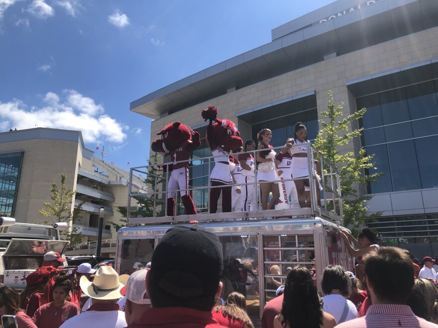 Arkansas Razorback fans gather around cheerleaders at the Hogs' first home game of the season in Fayetteville on Sept. 28, 2024.