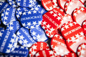 Collection of blue pins that say Democrat and red pins that say Republican