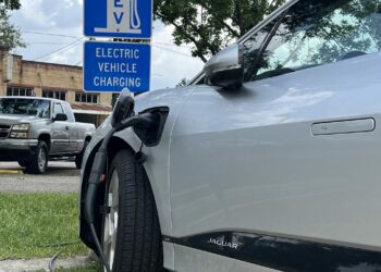 Electric car plugged into charging station