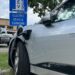 Electric car plugged into charging station