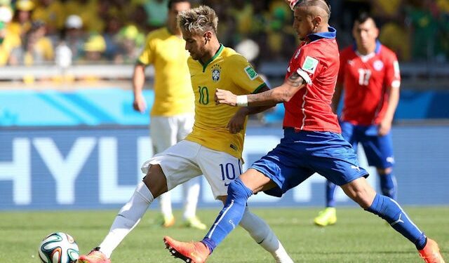 Brazil's Neymar and Chile's Arturo Vidal in action on June 28, 2014