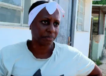 BBC Yusely, a woman wearing a T-shirt and white headband, looks into the camera
