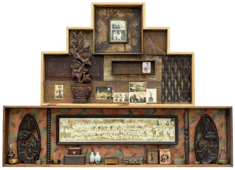 Image of a wooden cabinet with artifacts and documents. 