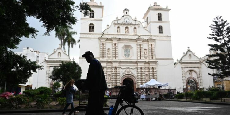 A man walks by on his bicycle in front of the San Miguel Arcangel Cathedral in the historic center of Tegucigalpa.