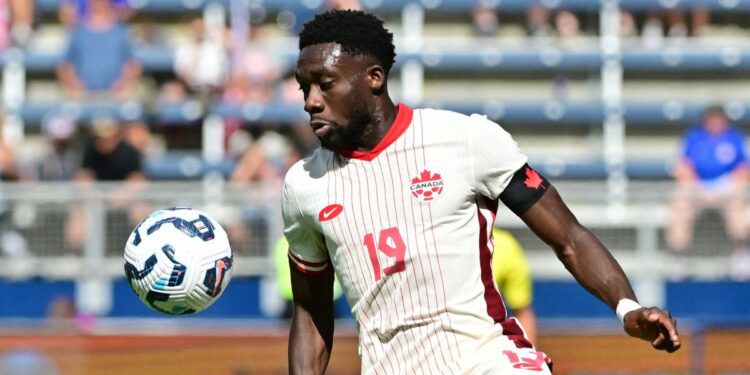 Canada&#039;s defender Alphonso Davies saves the ball from going out of bounds ahead of the Canada vs Panama live stream 2024 international friendly match