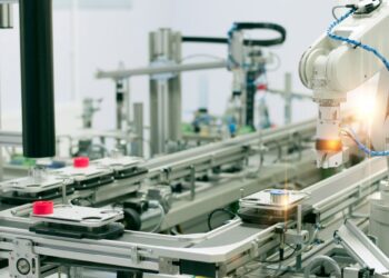 Image of a robotic arm in a manufacturing facility.