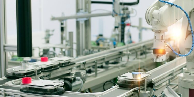 Image of a robotic arm in a manufacturing facility.
