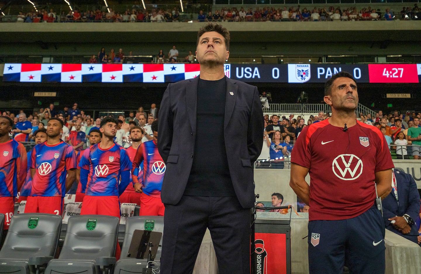 New US men's national team coach Mauricio Pochettino, along with his assistant coach Jesus Perez (right), stand for the national anthem before Saturday's 2-0 win over Panama in the Argentine's first game in charge. 