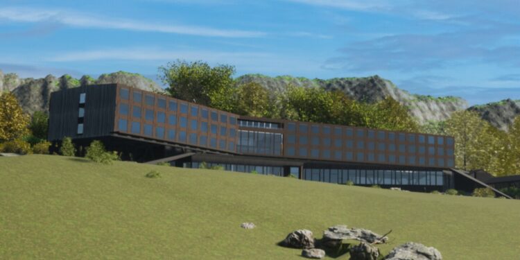 A rendering of the forthcoming hotel in Puerto Williams, Chile, currently being built by Silversea, featuring a sleek, modern, four-story box-like building, with mountains in the background