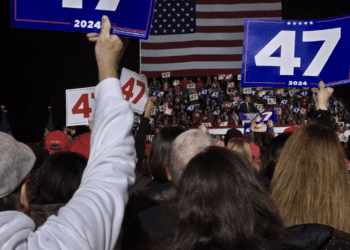 A crowd watches Republican former President Donald Trump speak at a rally in Novi as he campaigns for another term.