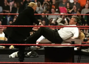 Donald Trump shoves Vince McMahon over a table in a wrestling ring during a WWE Monday Night Raw live show in 2007.