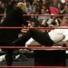 Donald Trump shoves Vince McMahon over a table in a wrestling ring during a WWE Monday Night Raw live show in 2007.
