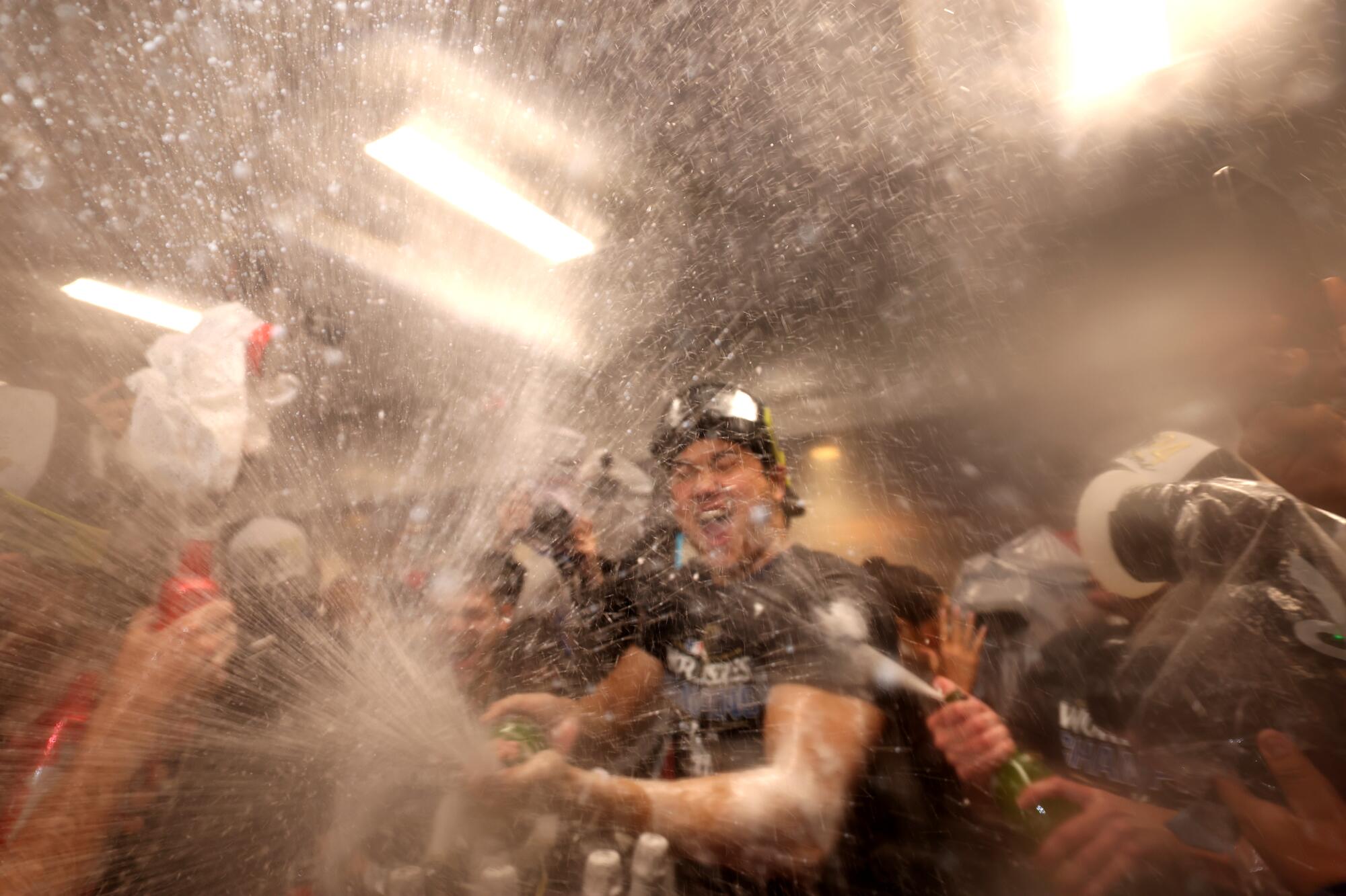 Dodgers players celebrate in the locker room after winning the World Series. Game 5 