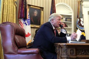 U.S. President Donald Trump speaks on the phone in the Oval Office of the White House June 27, 2017 in Washington, DC.