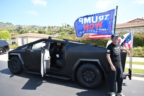 Jay Song, 54, U.S.-Korean supporter of former U.S. President and Republican presidential candidate Donald Trump stands by his Tesla Cybertruck flying a U.S. and 'Trump Won' flags as he tried to catch a glimpse of Trump giving a press conference outside Trump National Golf Club Los Angeles in Rancho Palos Verdes, California, on September 13, 2024