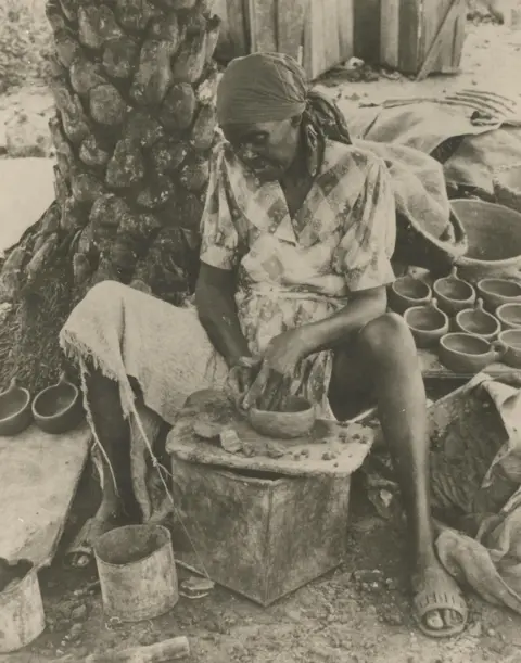 Courtesy of National Museum of Antigua and Barbuda Historical photo from the National Museum of Antigua and Barbuda of a woman making traditional pottery