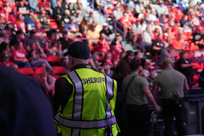 A man in a sheriff vest 