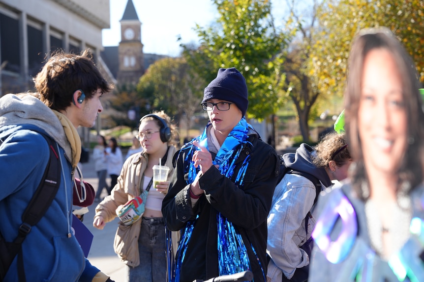 A teen boy in a blue beanie and glasses 