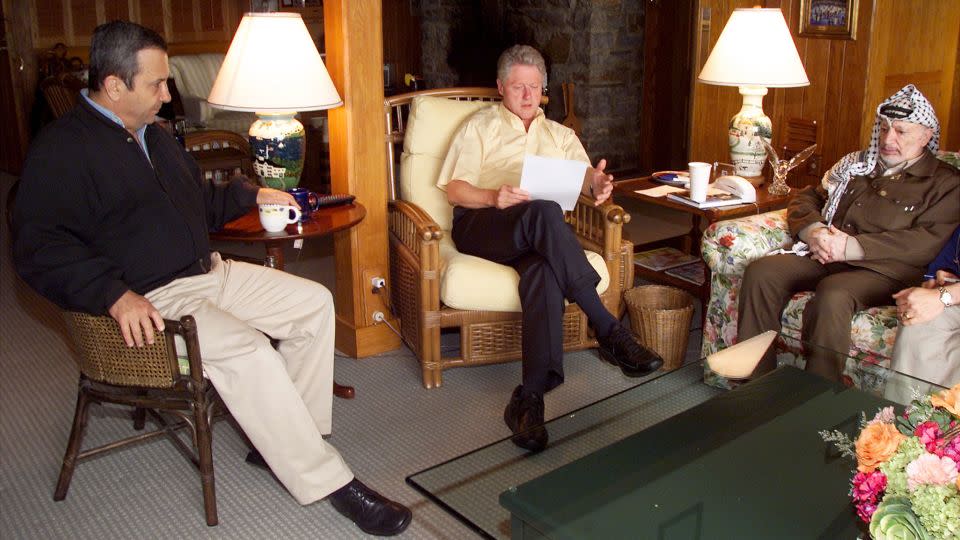 Clnton speaks during a morning meeting with Israeli Prime Minister Ehud Barak, left, and Palestinian Chairman Yasser Arafat at Camp David in Maryland on July 25, 2000. - Ralph Alswang/Newsmakers/Getty Images