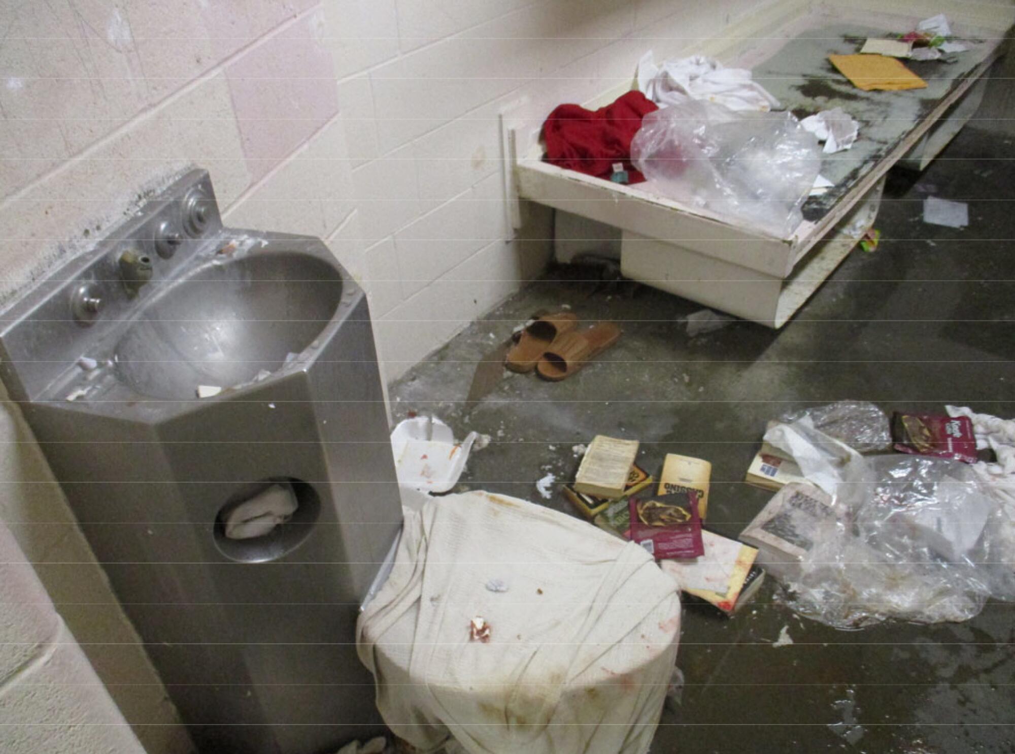 A jail cell in disarray.