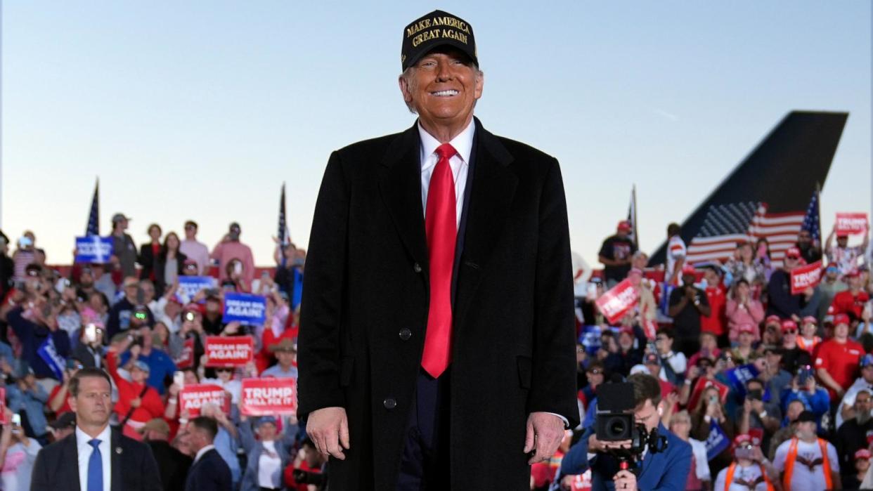 PHOTO: Republican presidential nominee former President Donald Trump smiles at a campaign rally at Kinston Regional Jetport, Nov. 3, 2024, in Kinston, N.C.  (Evan Vucci/AP)