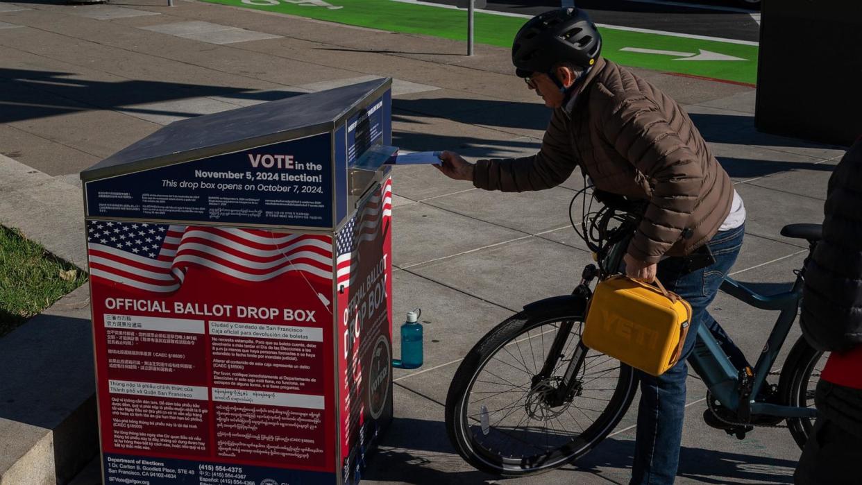 PHOTO: A voter drops off ballots at an official ballot drop box on the final day of early voting ahead of Election Day at City Hall, Nov. 4, 2024, in San Francisco, Calif.  (Loren Elliott/Getty Images)