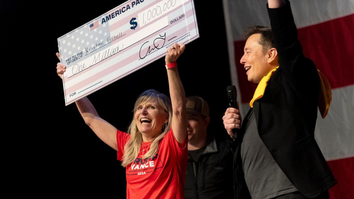 PHOTO: SpaceX and Tesla founder Elon Musk awarded Kristine Fishell with a $1 million check during the town hall at the Roxain Theater on October 20, 2024 in Pittsburgh, Pennsylvania. (Michael Swensen/Getty Images)