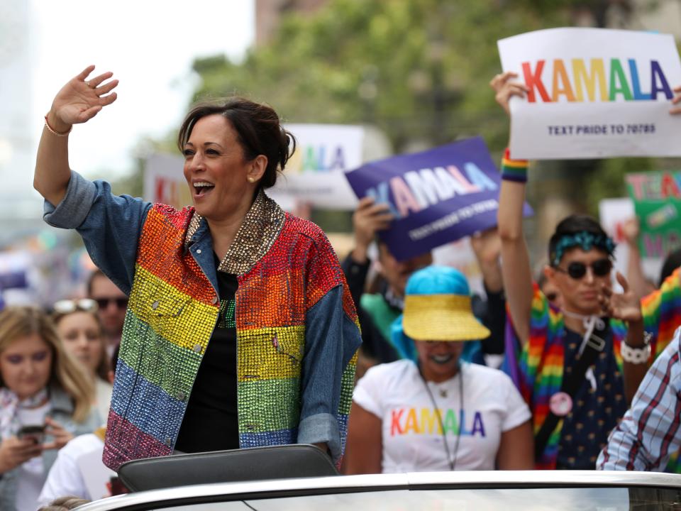 Senator Kamala Harris waves to the crowd as she rides in a car during the SF Pride Parade on June 30, 2019