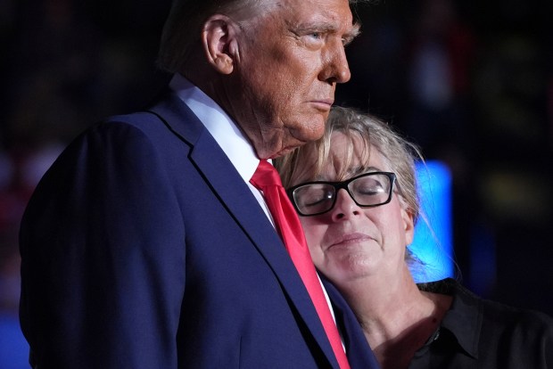 Republican presidential nominee former President Donald Trump embraces Patty Morin, mother of Rachel Morin, during a campaign rally