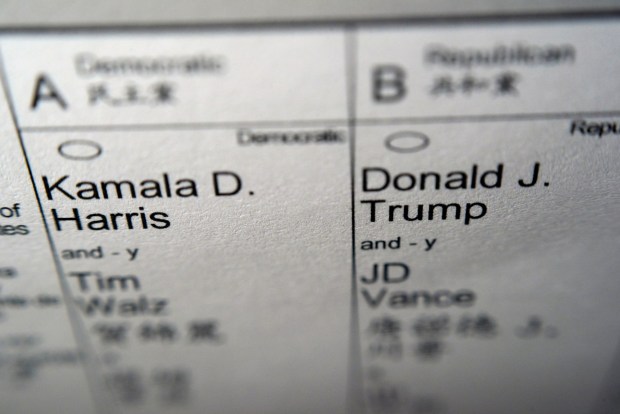 Candidates for president and vice president of the United States, Democrats Vice President Kamala Harris and Minnesota Gov. Tim Walz, and Republicans former President Donald Trump and Sen. JD Vance, R-Ohio, are seen on part of a mail-in election ballot