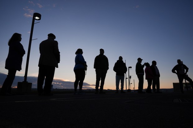 Voters wait in line to cast their ballots at Scranton...