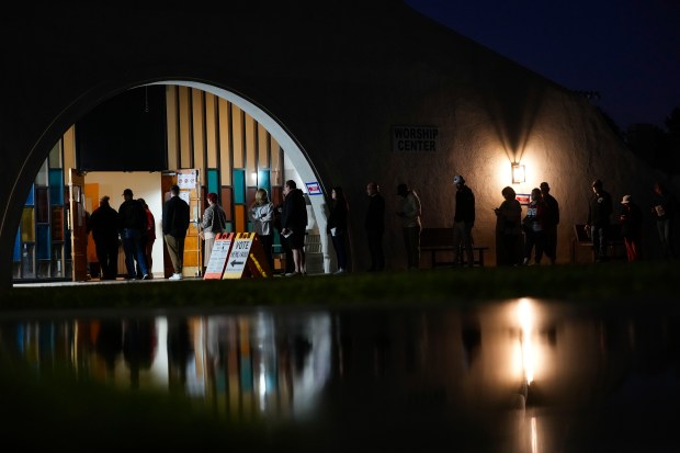 Voters stand in line outside a polling place at Madison...