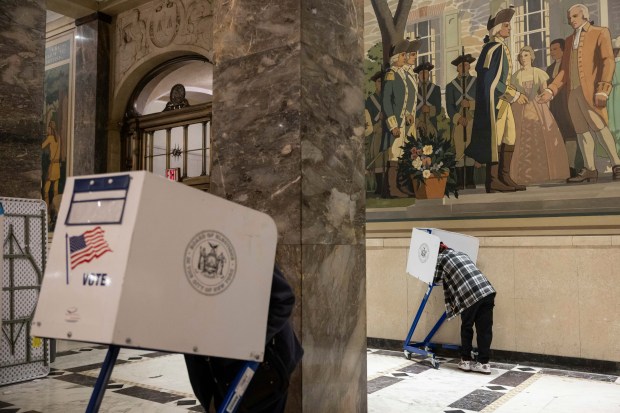 Voters cast their ballots at the Bronx County Supreme Court...