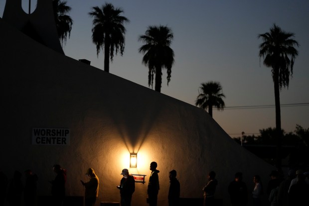 Voters stand in line outside a polling place at Madison...