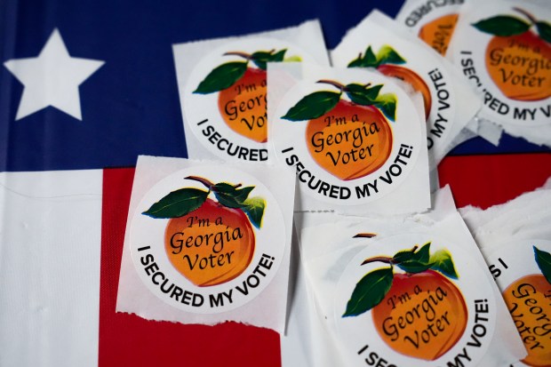 Stickers lay on a table inside a polling place, Tuesday,...